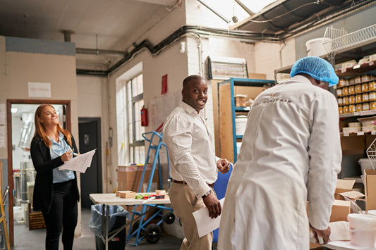Warehouse staff managing bulk honey orders and inventory in a bright, organized facility.
